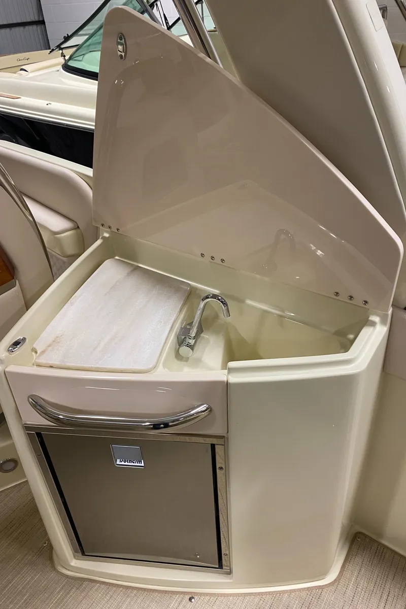 Slide: The Image of 2025 Chris-Craft Launch 28 GT boat interior with sink and storage compartment. - 10