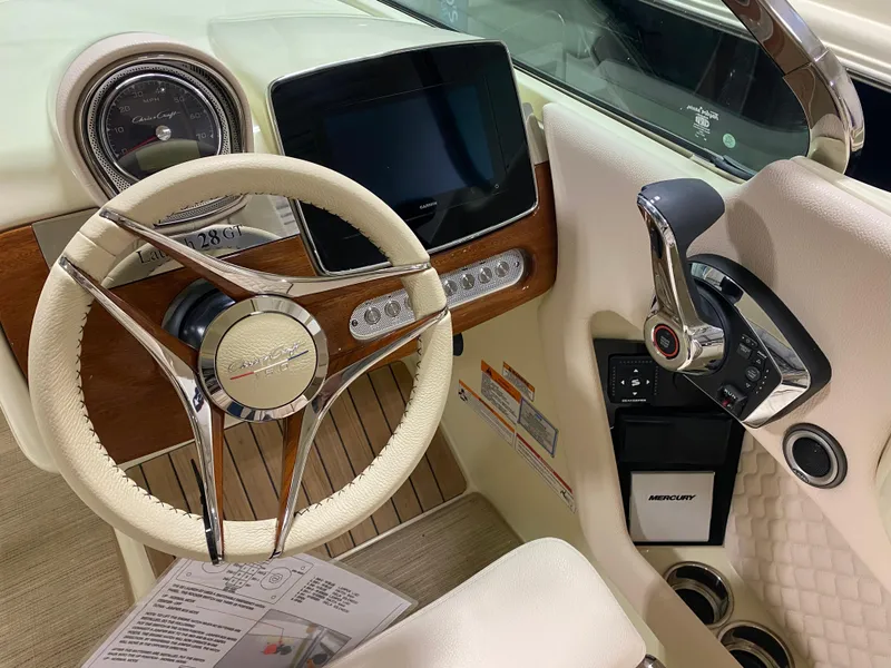 Slide: The Image of 2025 Chris-Craft Launch 28 GT dashboard with steering wheel and control panel. - 15