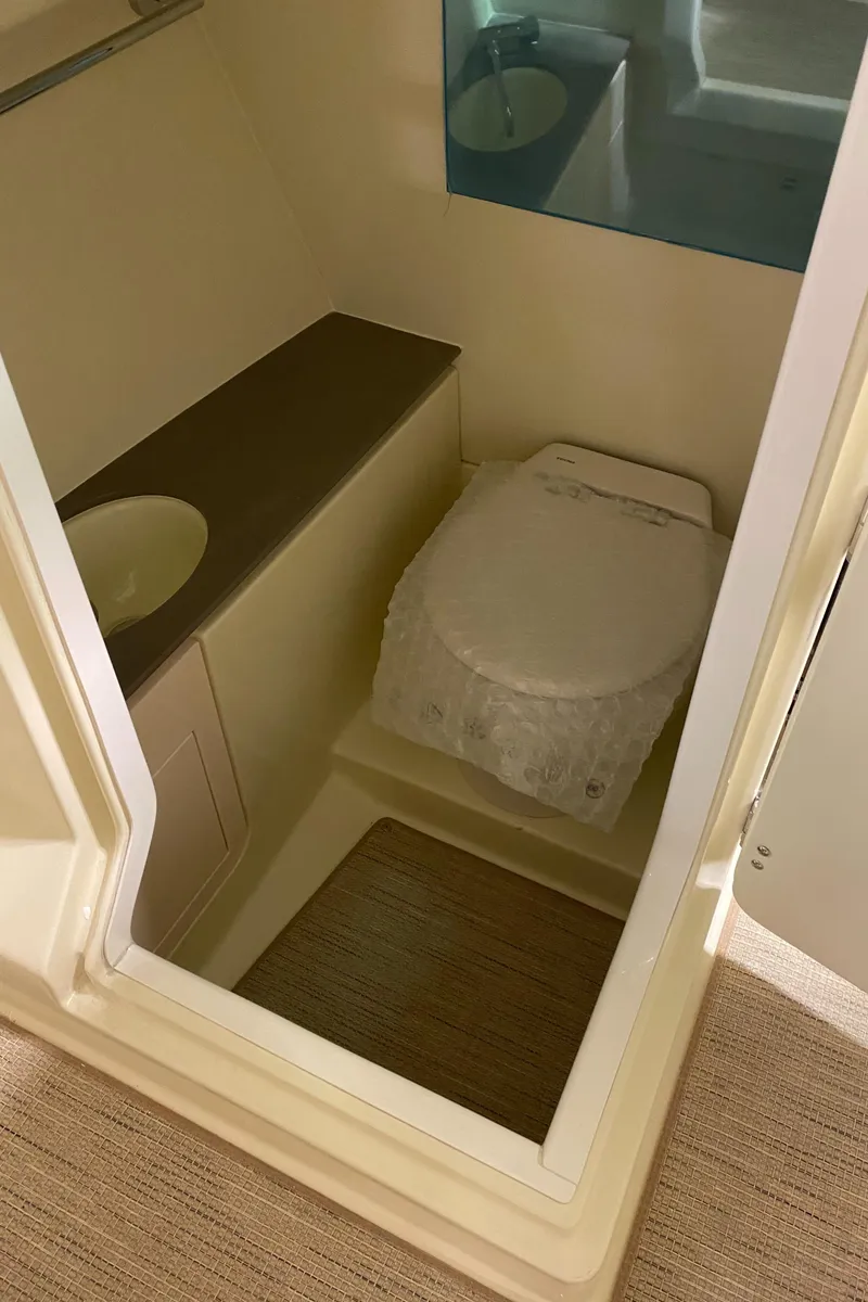 Slide: The Image of 2025 Chris-Craft Launch 28 GT boat bathroom interior with sink and toilet. - 18