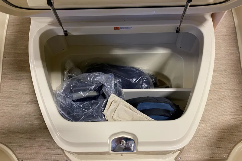 Slide: The Image of Storage compartment on 2026 Chris-Craft Catalina 28 boat, containing bags and gear. - 19