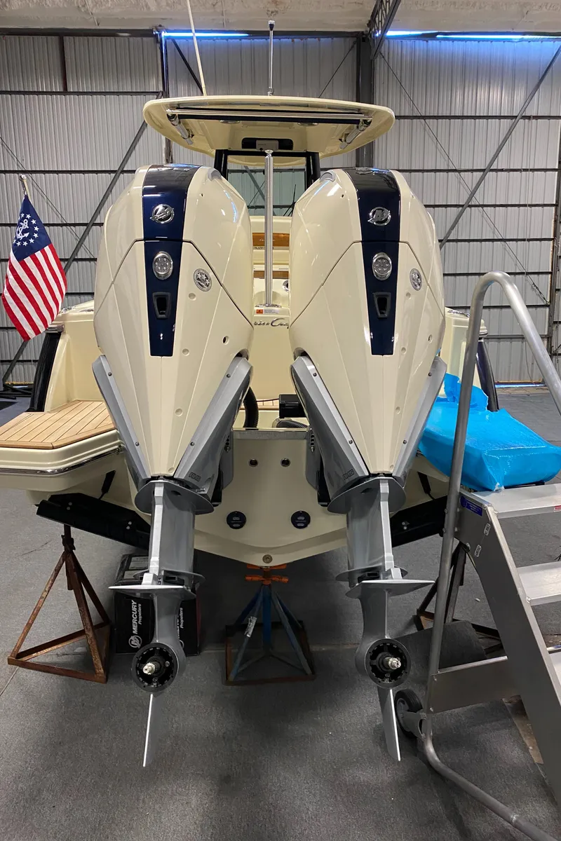 Slide: The Image of 2026 Chris-Craft Catalina 28 with dual outboard engines in a boatyard setting. - 5