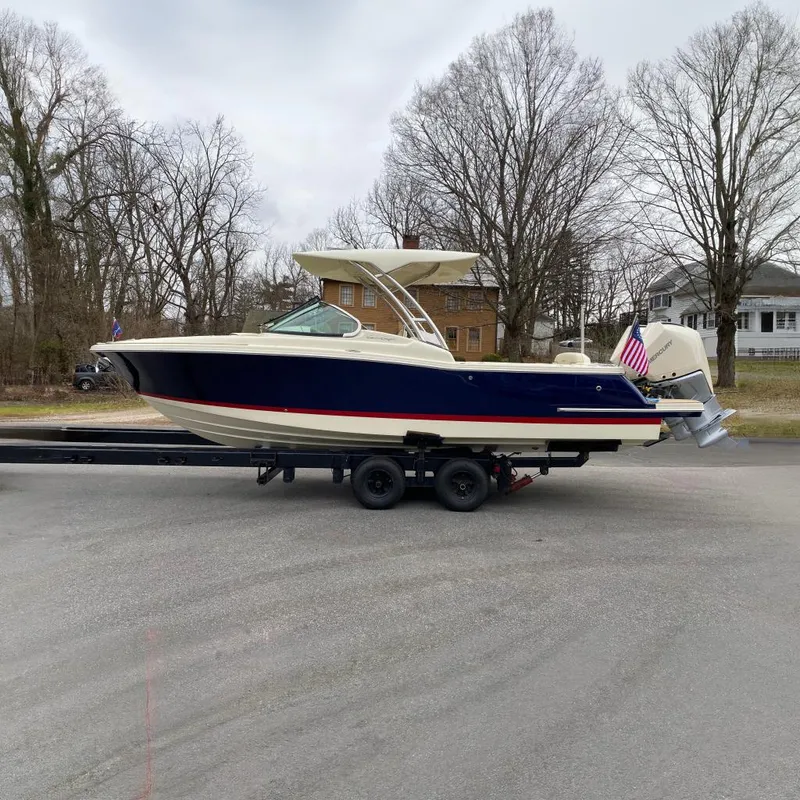 The Image of 2024 Chris-Craft Calypso 28 boat on trailer, side view, outdoors. - 0
