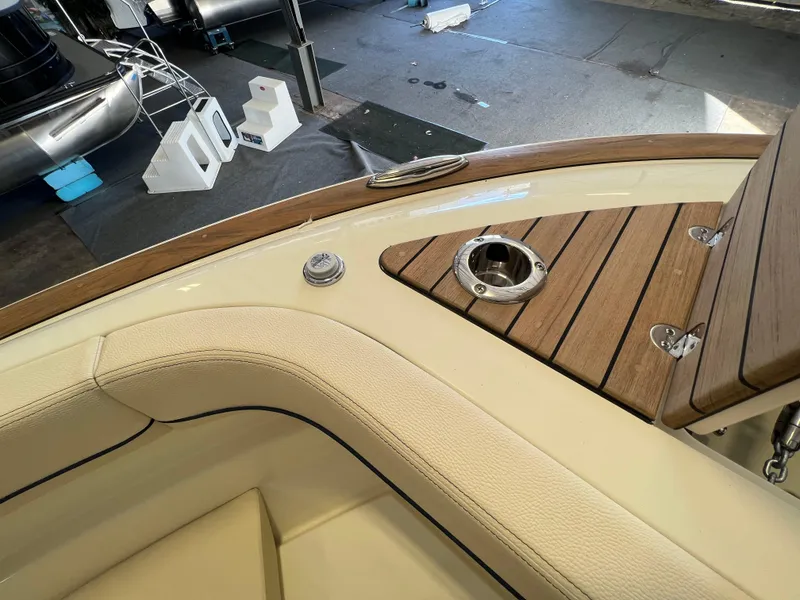 Slide: The Image of 2024 Chris-Craft Calypso 28 boat interior with teak accents and stainless steel fixtures. - 16