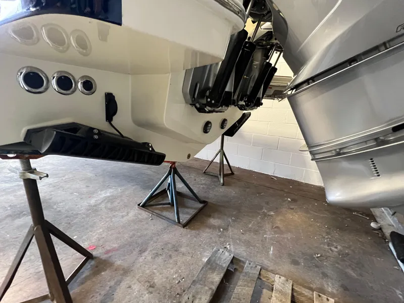 Slide: The Image of 2024 Chris-Craft Calypso 28 boat on stands in a garage. - 17