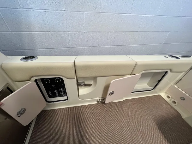 Slide: The Image of 2024 Chris-Craft Calypso 28 boat interior storage compartments and control panel. - 22