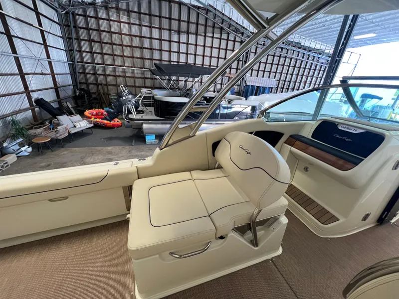 Slide: The Image of 2024 Chris-Craft Calypso 28 interior view in a boat storage facility. - 25