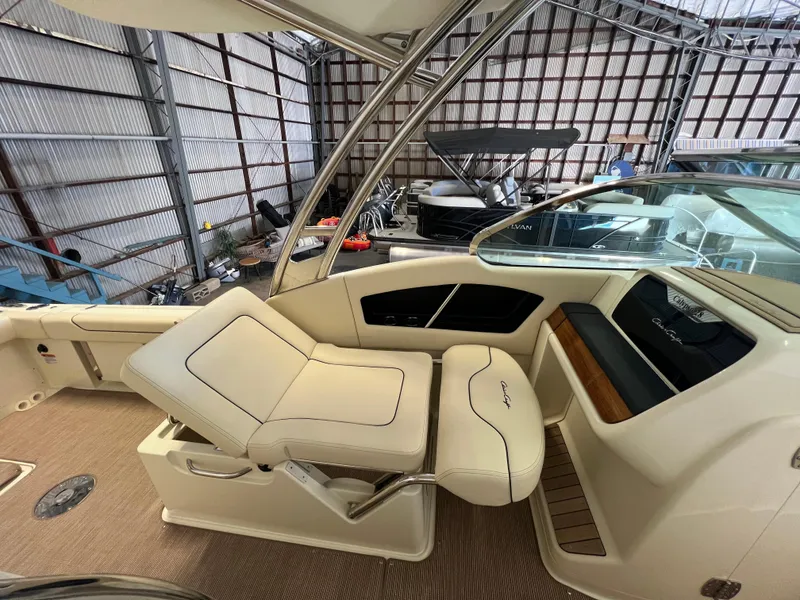 Slide: The Image of 2024 Chris-Craft Calypso 28 boat interior with luxurious seating in a marina. - 27