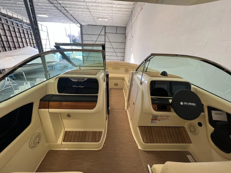 Slide: The Image of 2024 Chris-Craft Calypso 28 boat interior with dual consoles and wooden accents. - 28