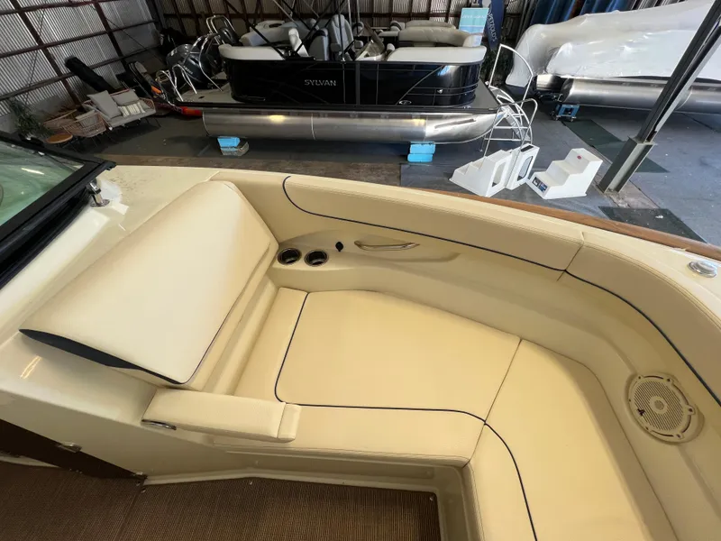 Slide: The Image of 2024 Chris-Craft Calypso 28 boat interior with beige seating and cup holders. - 31