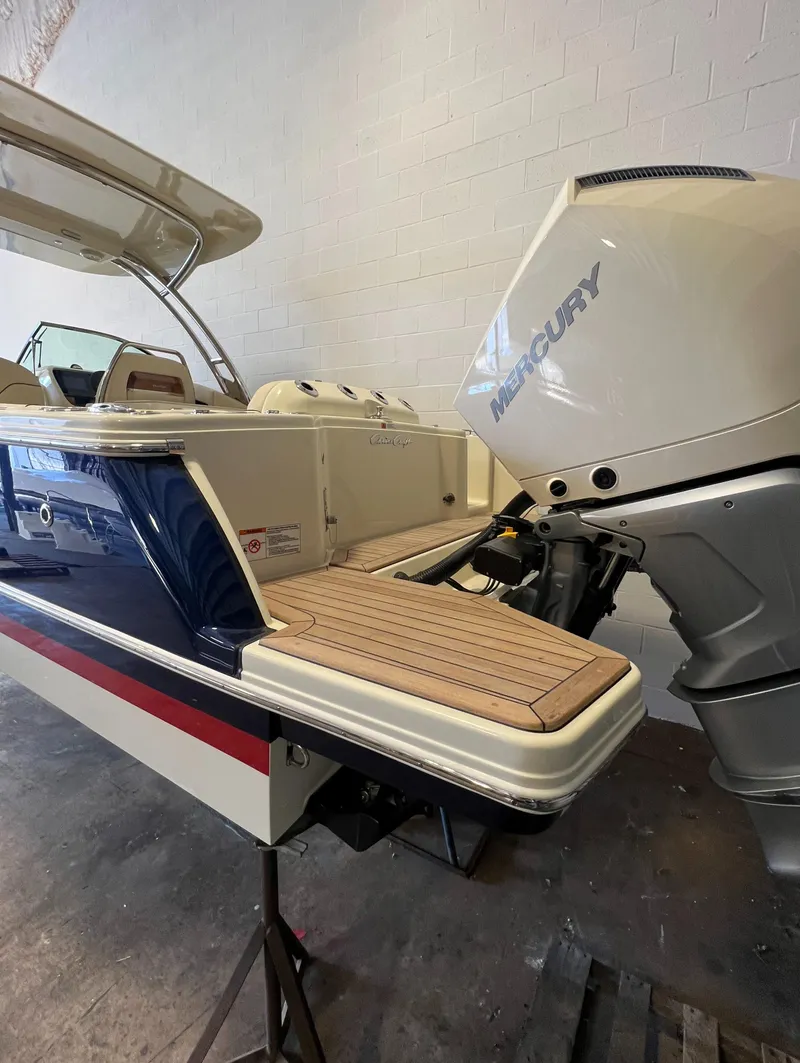 Slide: The Image of 2024 Chris-Craft Calypso 28 boat with Mercury outboard engine in a showroom. - 35