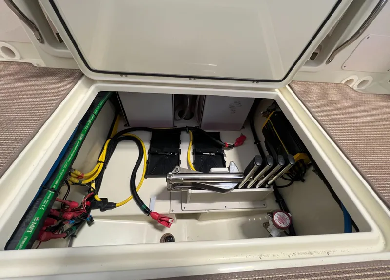 Slide: The Image of 2024 Chris-Craft Calypso 28 engine compartment with wiring and battery setup. - 39
