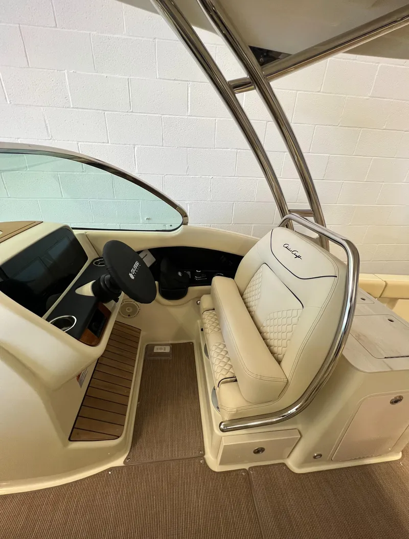 Slide: The Image of 2024 Chris-Craft Calypso 28 helm station with luxurious seating and modern controls. - 47
