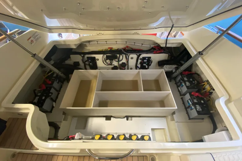 Slide: The Image of Open engine compartment of 2026 Chris-Craft Launch 31 GT boat, showcasing battery setup. - 19