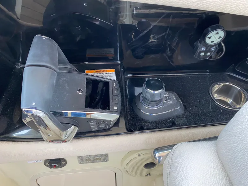 Slide: The Image of 2024 Chris-Craft Calypso 32 helm controls and joystick on black console. - 14