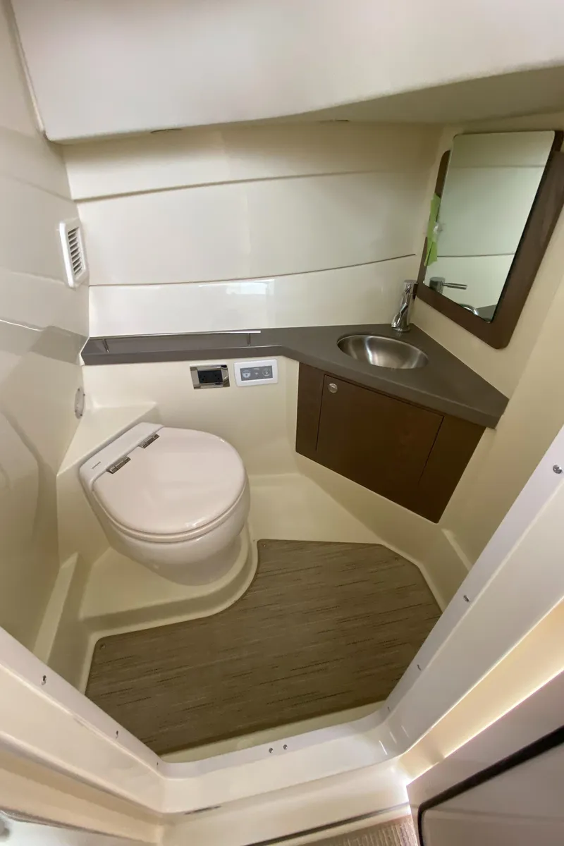 Slide: The Image of 2024 Chris-Craft Calypso 32 boat bathroom with modern fixtures and wooden cabinetry. - 17