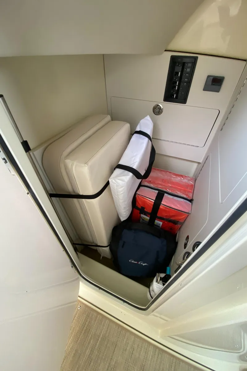 Slide: The Image of Storage compartment in 2024 Chris-Craft Calypso 32 boat with cushions and gear. - 18