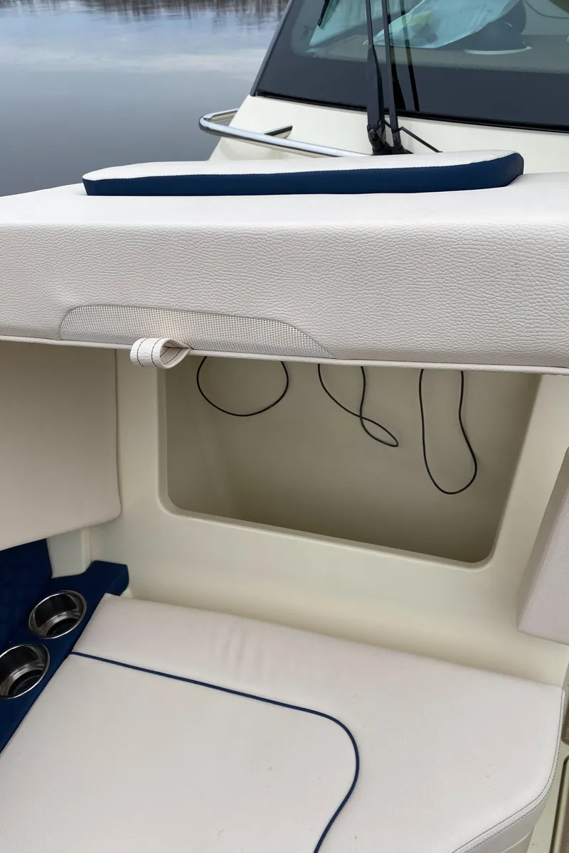 Slide: The Image of 2024 Chris-Craft Calypso 32 boat interior with white and blue seating. - 22