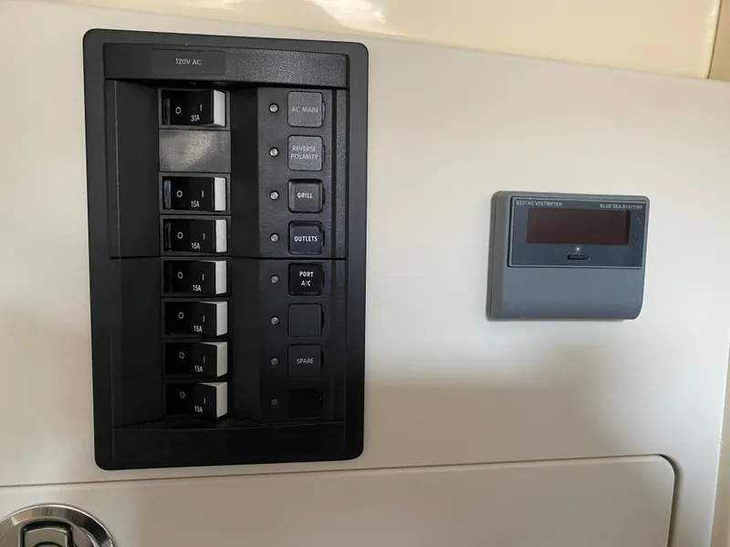 Slide: The Image of Electrical panel and control display on 2024 Chris-Craft Calypso 32 boat. - 23