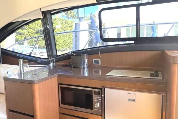 Slide: The Image of Cozy bedroom interior of 2016 Sea Ray Sundancer 400 yacht with plush bedding. - 19