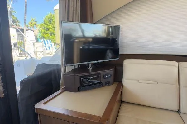 Slide: The Image of 2016 Sea Ray Sundancer 400 bathroom with glass sink and wooden cabinetry. - 22