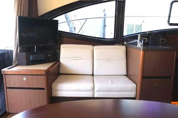 Slide: The Image of 2016 Sea Ray Sundancer 400 helm with navigation screens and steering wheel. - 36