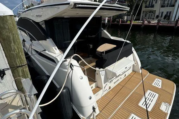 Slide: The Image of 2016 Sea Ray Sundancer 400 boat deck with black cover and railing. - 43
