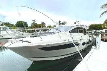 Slide: The Image of Interior cockpit of 2016 Sea Ray Sundancer 400 yacht with modern controls and leather seating. - 54