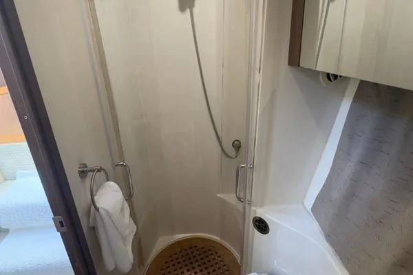 Slide: The Image of Interior cabin of 2016 Sea Ray 400 Sundancer with cozy bed and pillows. - 6