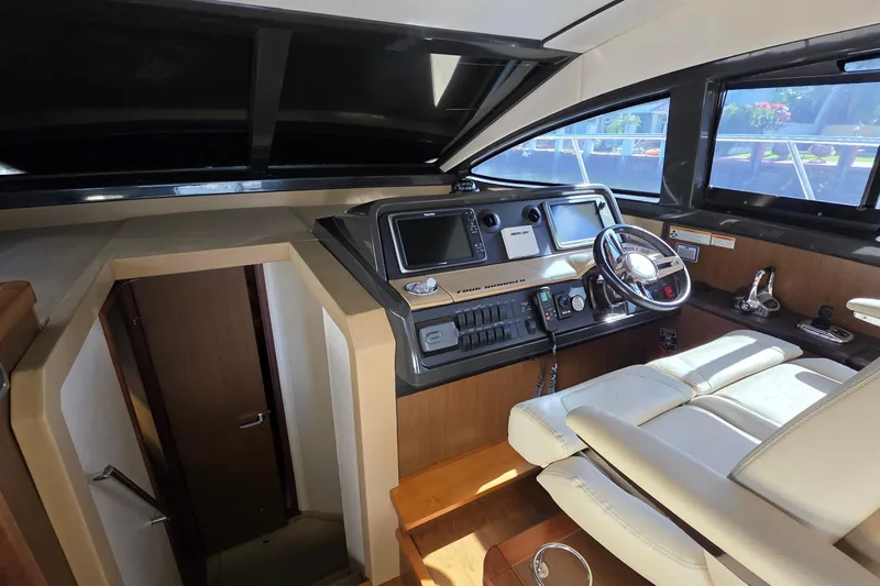 Slide: The Image of 2016 Sea Ray Sundancer 400 helm with modern controls and comfortable seating. - 64