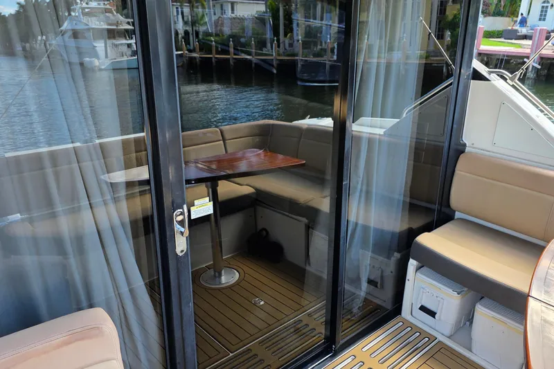 Slide: The Image of 2016 Sea Ray Sundancer 400 yacht interior with seating and table by the water. - 74