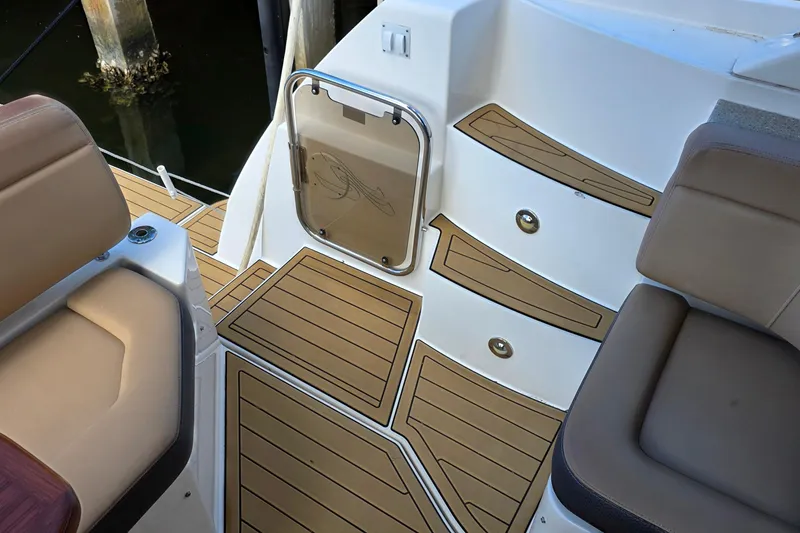 Slide: The Image of 2016 Sea Ray Sundancer 400 boat deck with tan seating and wood-style flooring. - 76