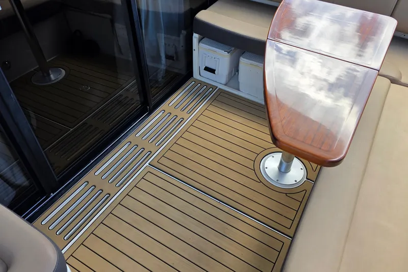 Slide: The Image of 2016 Sea Ray Sundancer 400 interior with wooden table and cushioned seating. - 78