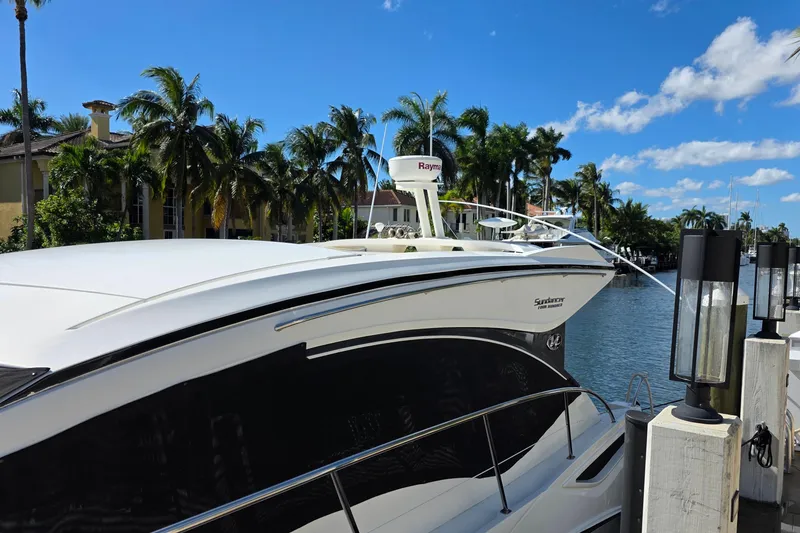 Slide: The Image of 2016 Sea Ray Sundancer 400 yacht docked by palm trees and waterfront homes. - 81