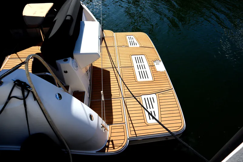 Slide: The Image of 2016 Sea Ray Sundancer 400 swim platform on calm water. - 82