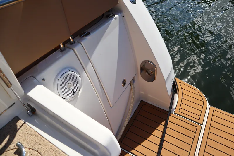 Slide: The Image of 2016 Sea Ray Sundancer 400 boat deck with wood finish and water view. - 85