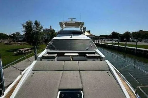 Slide: The Image of 2020 Azimut 66 yacht docked, featuring spacious sunbathing area and sleek design. - 11