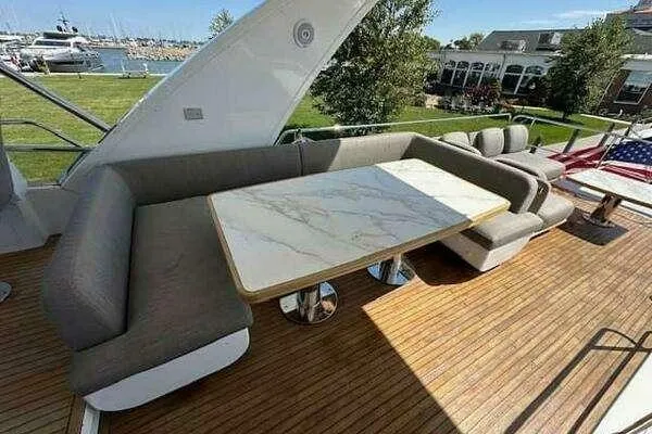 Slide: The Image of Luxury seating area on 2020 Azimut 66 yacht with marble table and wooden deck. - 18