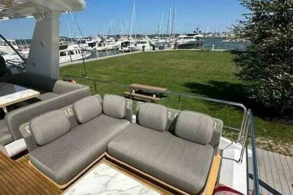 Slide: The Image of Luxurious 2020 Azimut 66 yacht with plush seating, docked at a marina. - 22