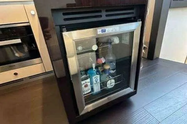 Slide: The Image of Mini fridge stocked with beverages inside a 2020 Azimut 66 yacht kitchen. - 35