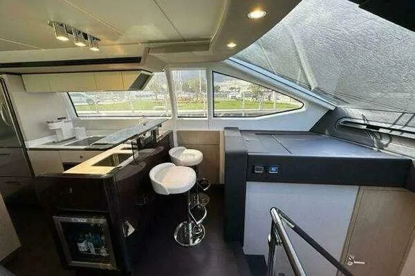 Slide: The Image of Luxurious interior of a 2020 Azimut 66 yacht with modern kitchen and seating area. - 41