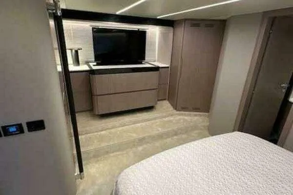 Slide: The Image of 2020 Azimut 66 yacht interior with modern bedroom and entertainment setup. - 45