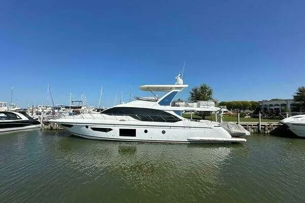 Slide: The Image of 2020 Azimut 66 yacht docked in a marina under clear blue skies. - 5