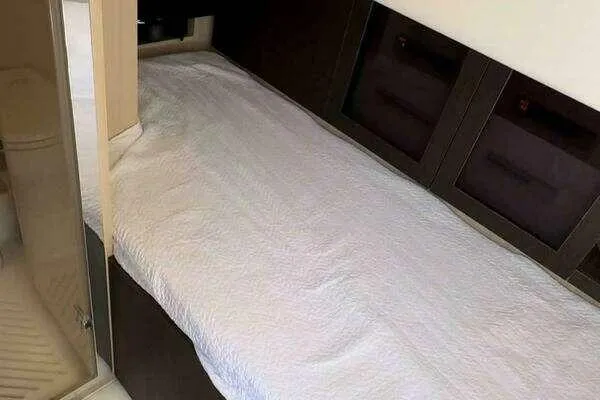 Slide: The Image of 2020 Azimut 66 yacht interior with a neatly made bed and modern design. - 53