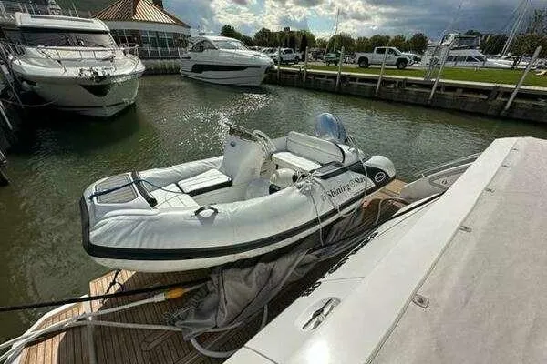 Slide: The Image of 2020 Azimut 66 yacht docked with inflatable boat on deck. - 55