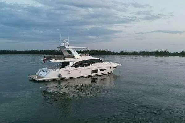 Slide: The Image of 2020 Azimut 66 yacht on calm water under a cloudy sky. - 6