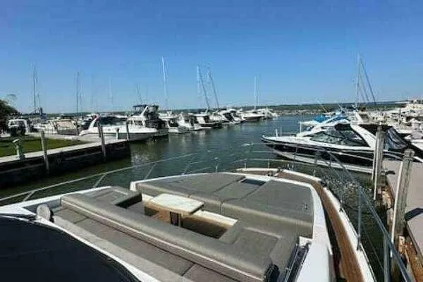 Slide: The Image of Luxury Azimut 66 yacht docked at marina, 2020 model, with spacious sunbathing area. - 8