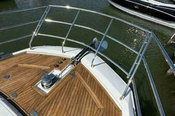 Slide: The Image of Bow of a 2020 Azimut 66 yacht with teak decking and stainless steel railings. - 9
