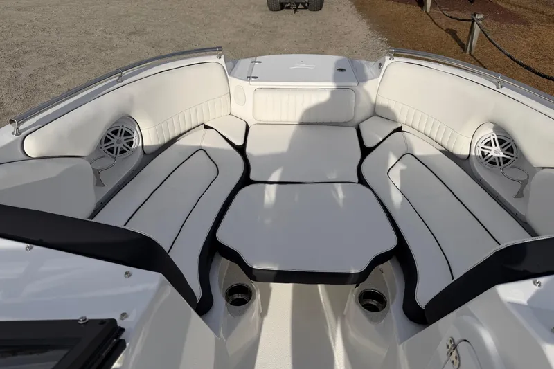 Slide: The Image of 2026 Stingray 211 DC boat interior with white seating and built-in speakers. - 10