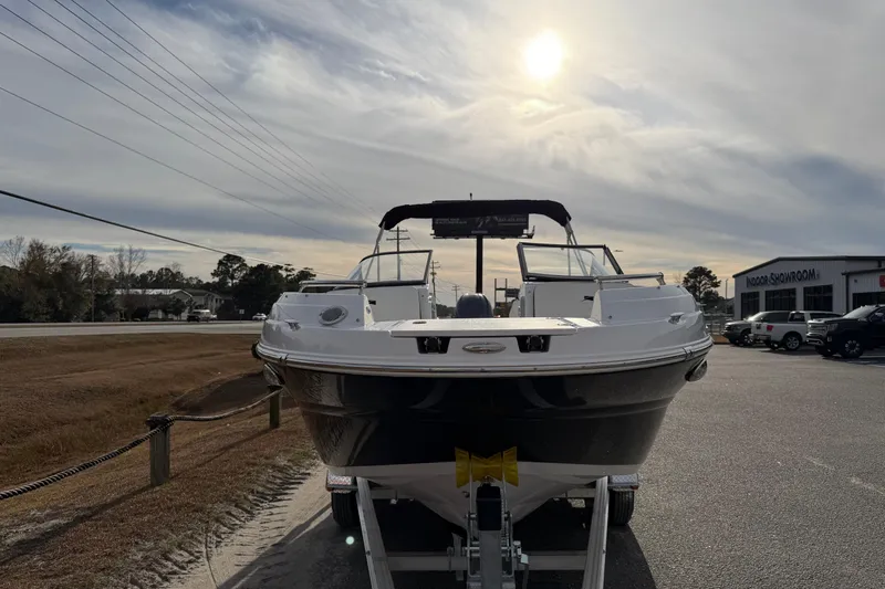 Slide: The Image of 2026 Stingray 211 DC boat on trailer under cloudy sky. - 7