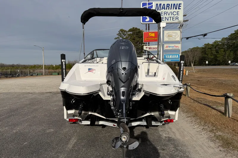 Slide: The Image of 2026 Stingray 211 DC boat with Yamaha outboard motor at marine service center. - 8